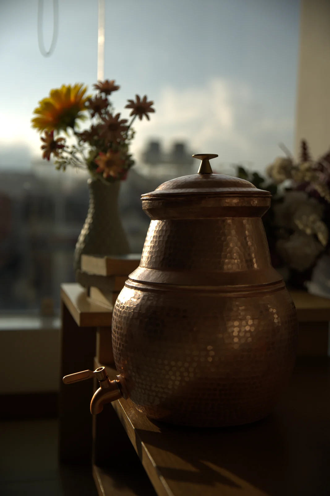Tamakala copper water dispenser by the window