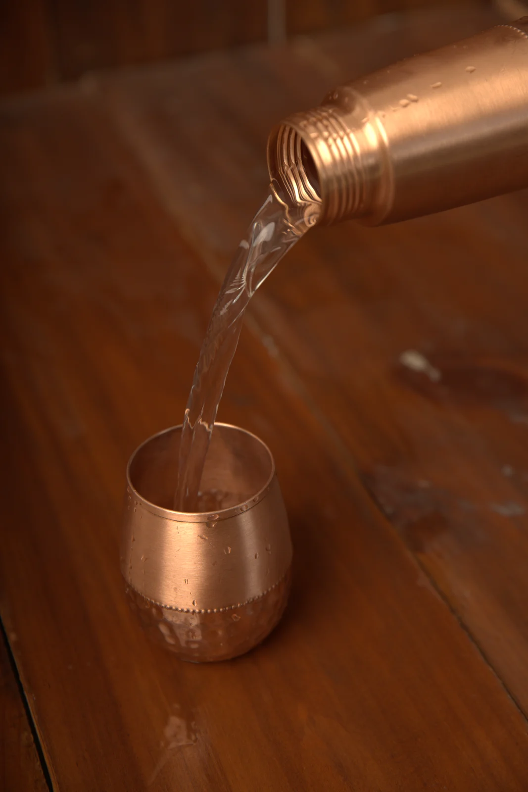 Water being poured from a Tamakala copper vessel