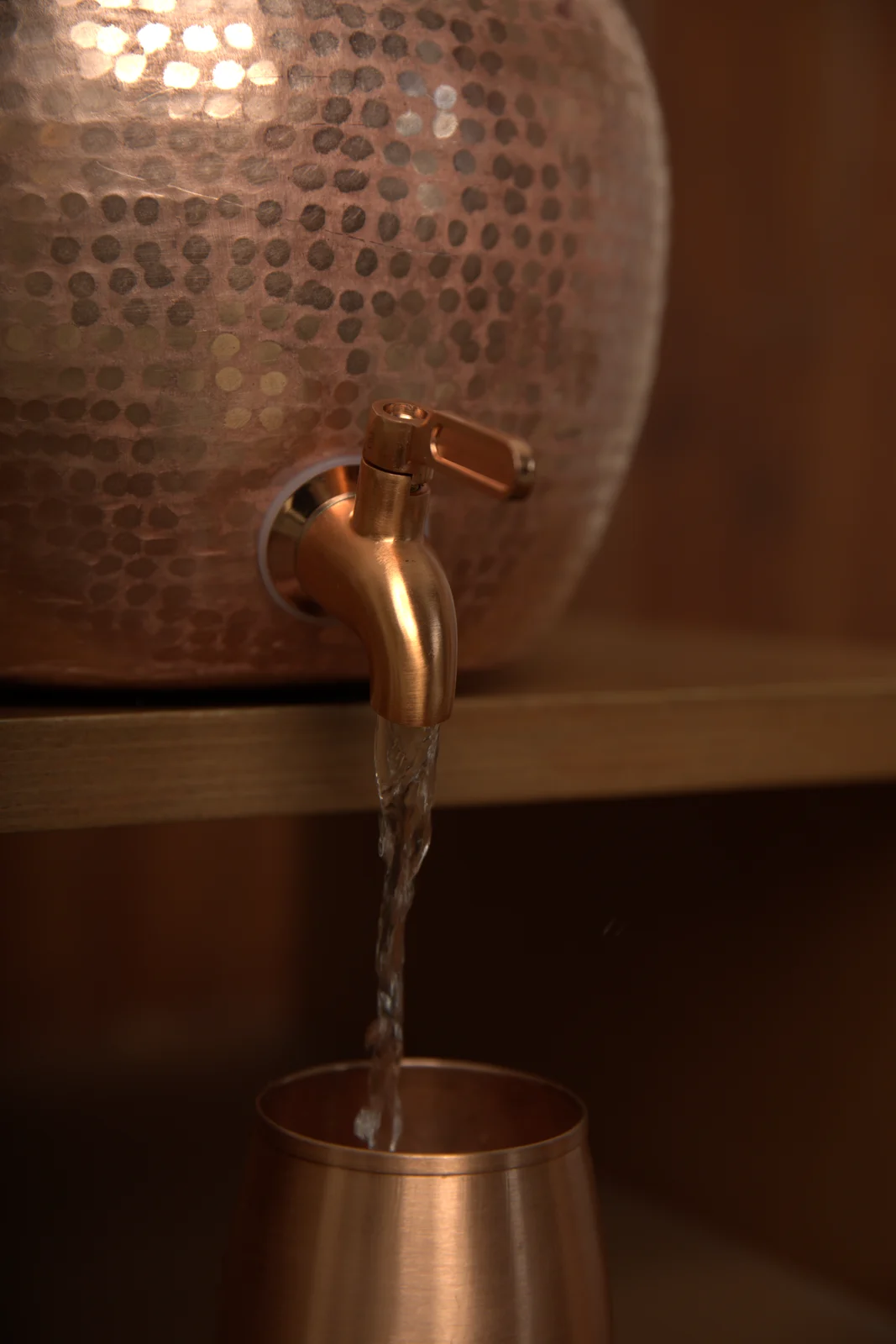 Water pouring from the Tamakala copper dispenser